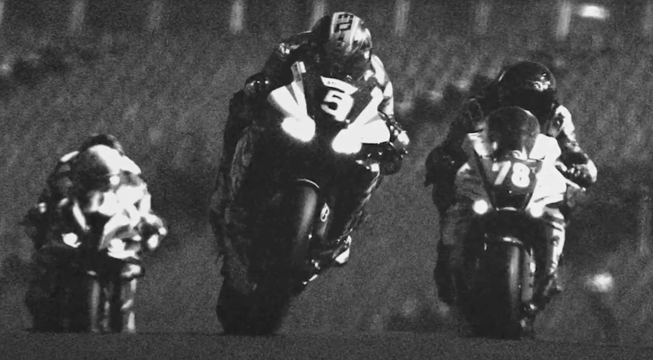 Three people on motorcycles in black and white