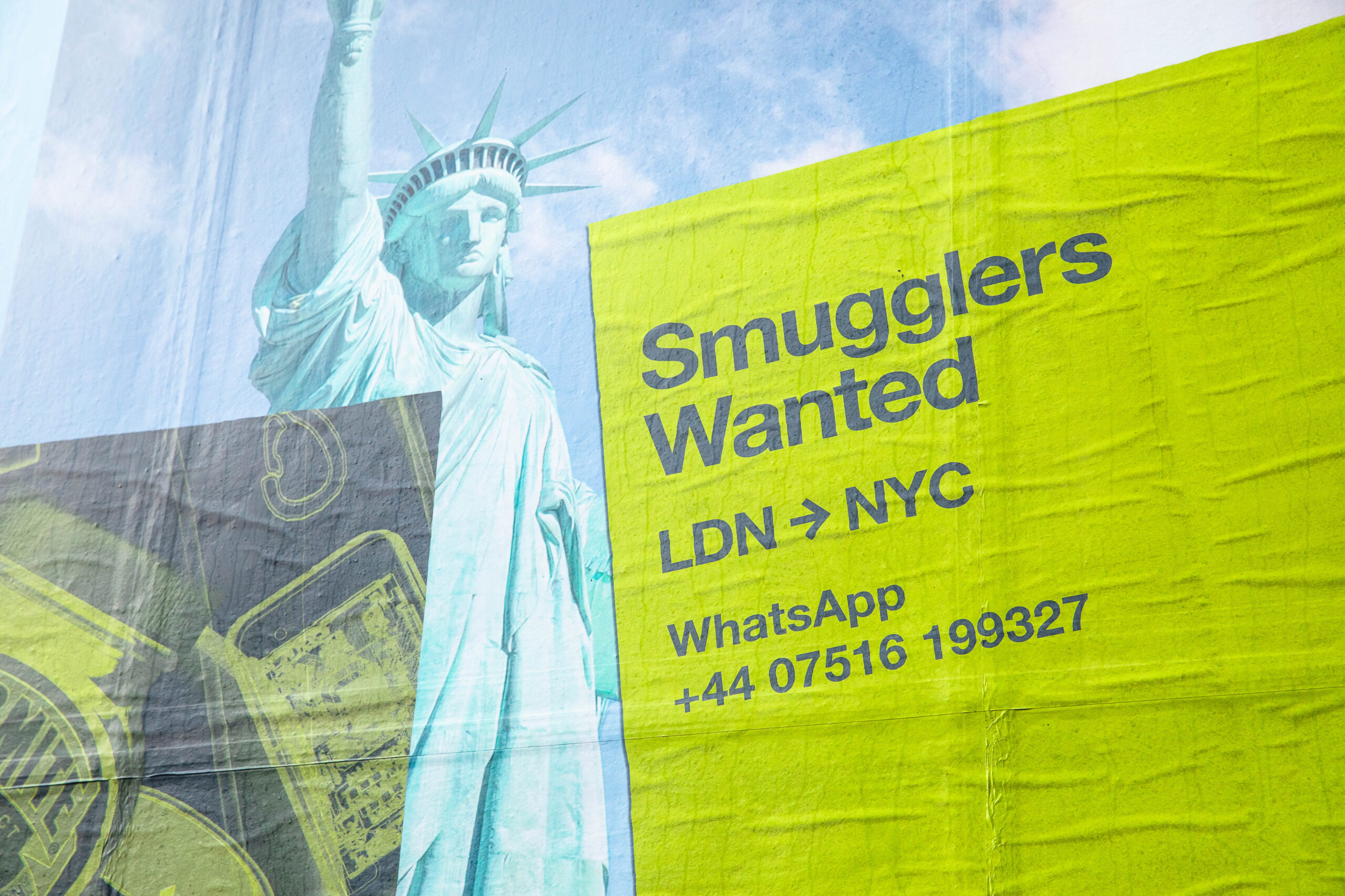 Smugglers campaign “wanted” sign pasted on NYC wall